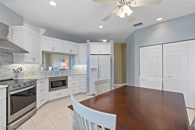 kitchen with ceiling fan, light tile floors, backsplash, white cabinetry, and stainless steel appliances