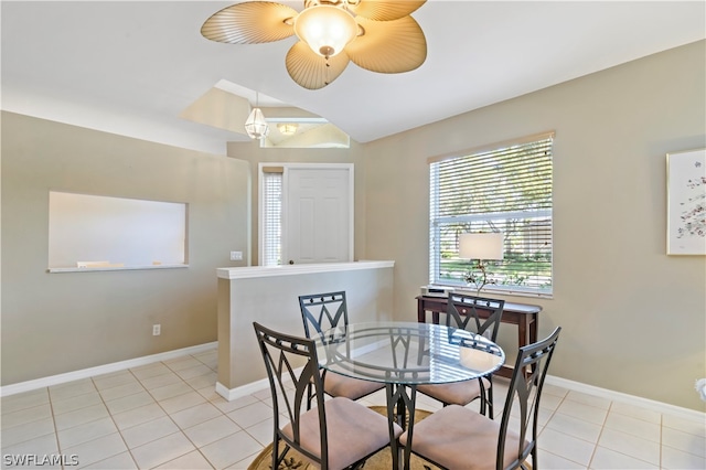 tiled dining space featuring ceiling fan