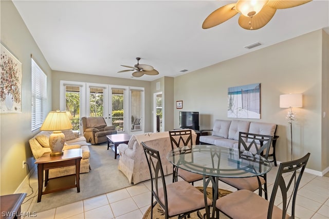 tiled dining area with french doors and ceiling fan