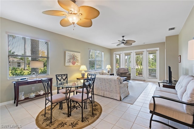 tiled living room featuring ceiling fan and french doors