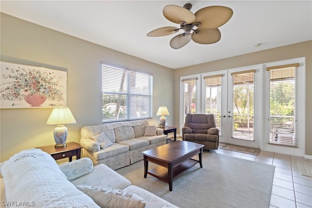 tiled living room with french doors, a healthy amount of sunlight, and ceiling fan