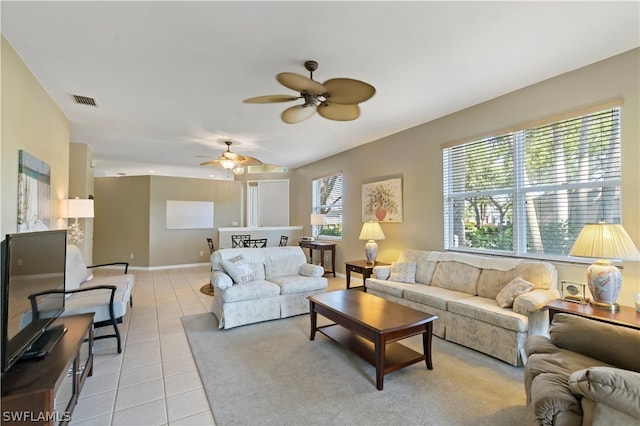 living room with ceiling fan and light tile flooring