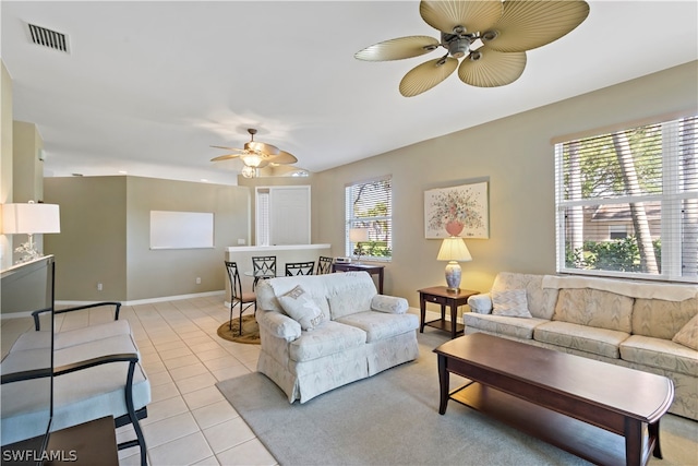 living room with plenty of natural light, ceiling fan, and light tile flooring