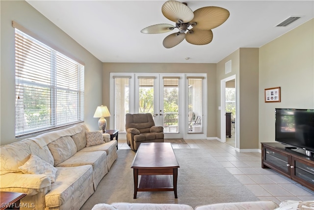 living room with french doors, ceiling fan, light tile floors, and plenty of natural light