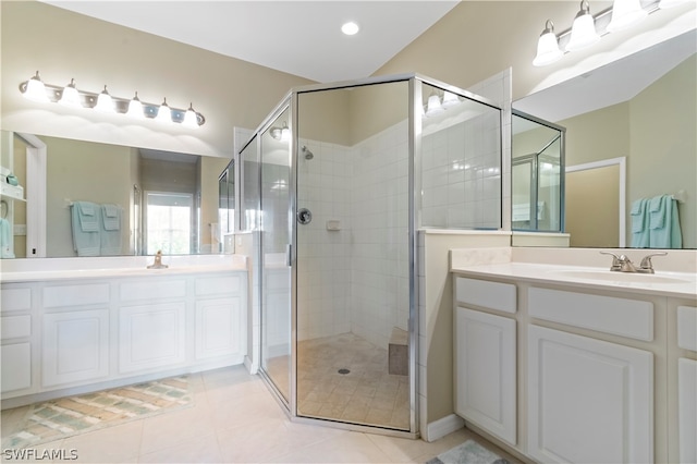 bathroom with a shower with door, tile floors, and vanity