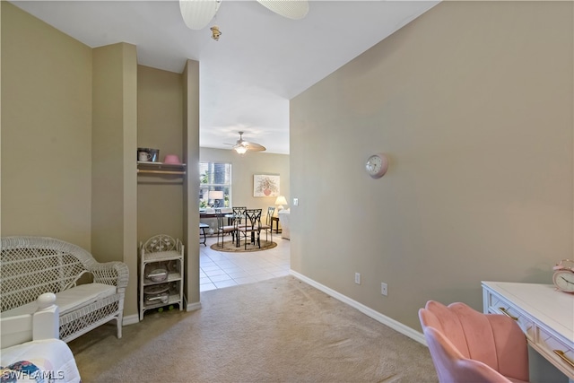 interior space with ceiling fan and light carpet