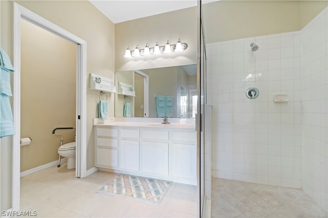 bathroom with tiled shower, vanity, toilet, and tile flooring