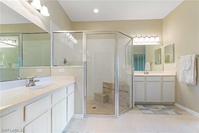 bathroom with double sink vanity, a shower with shower door, and tile flooring