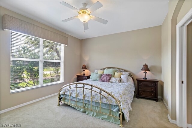 bedroom with light colored carpet and ceiling fan