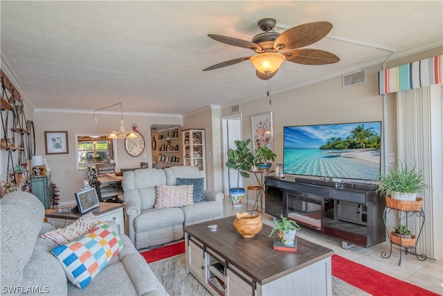 tiled living room with a textured ceiling, ceiling fan, and crown molding