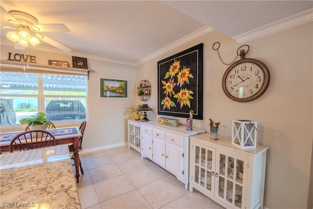 interior space featuring a textured ceiling, ceiling fan, crown molding, and light tile floors