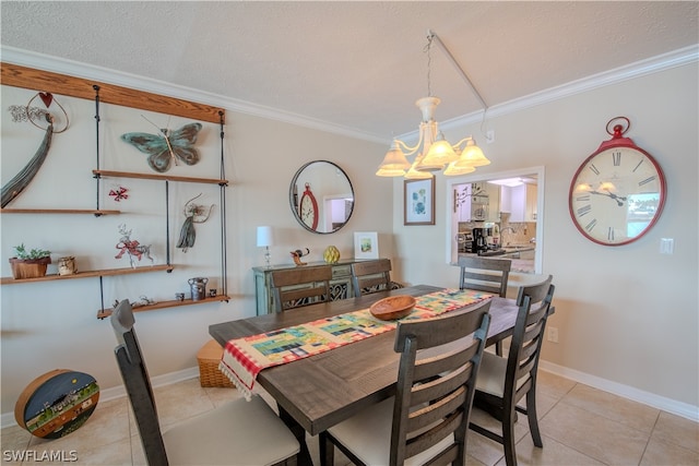 tiled dining area featuring a textured ceiling, sink, crown molding, and an inviting chandelier