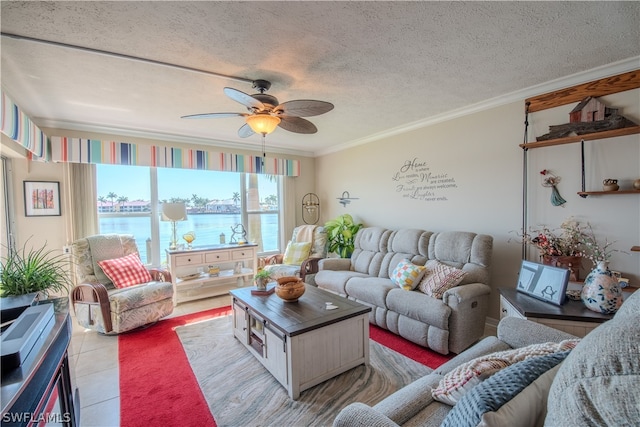 living room with a water view, ceiling fan, crown molding, a textured ceiling, and light tile floors