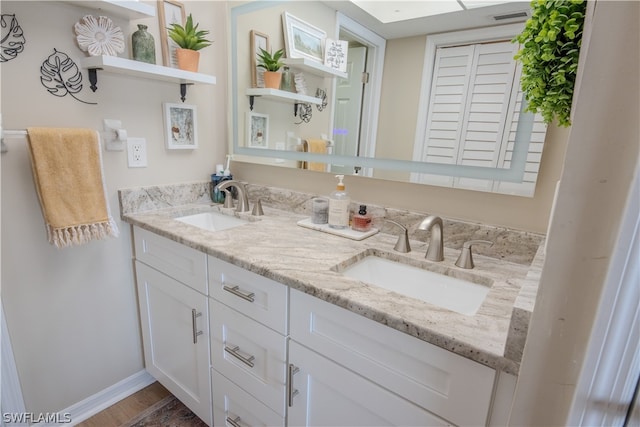 bathroom featuring hardwood / wood-style floors and double sink vanity