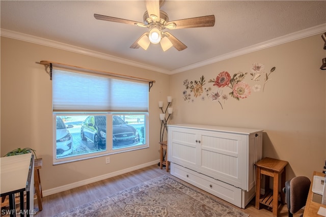 bedroom with ornamental molding, ceiling fan, and hardwood / wood-style floors