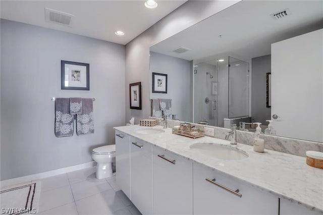 bathroom with a shower with shower door, dual bowl vanity, toilet, and tile flooring