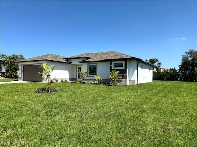 view of front of home featuring a front yard and a garage