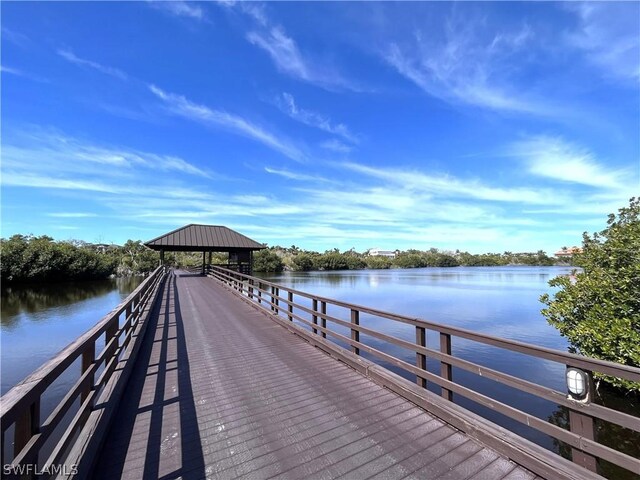 view of dock with a gazebo and a water view