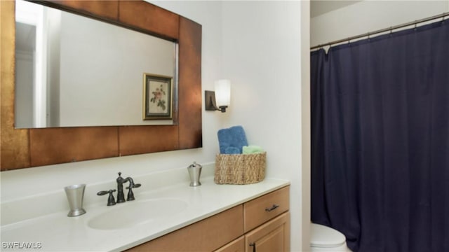 bathroom featuring vanity, toilet, and walk in shower