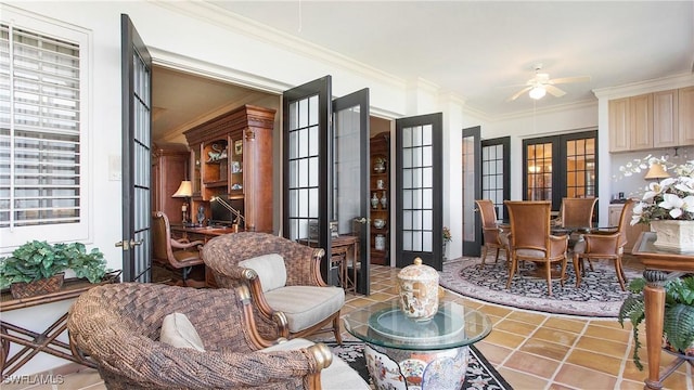 sitting room with ceiling fan, a wealth of natural light, ornamental molding, tile patterned floors, and french doors