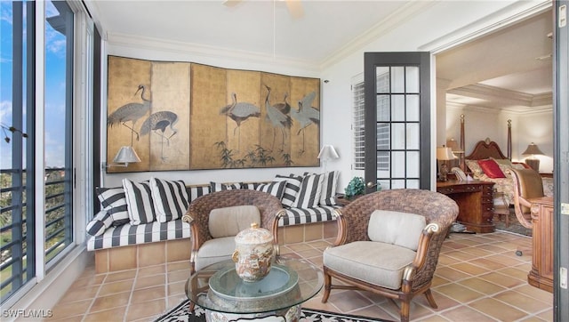 sitting room featuring tile patterned floors, ornamental molding, and ceiling fan