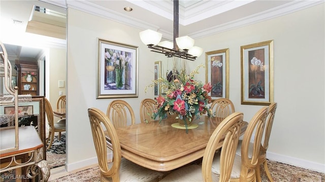 dining space with ornamental molding and a chandelier