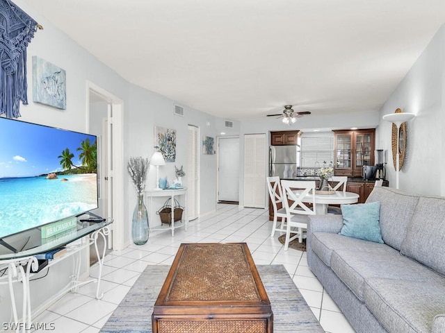 living room with ceiling fan and light tile floors