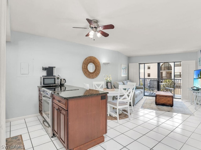 kitchen with ceiling fan, light tile floors, electric range, and dark stone counters