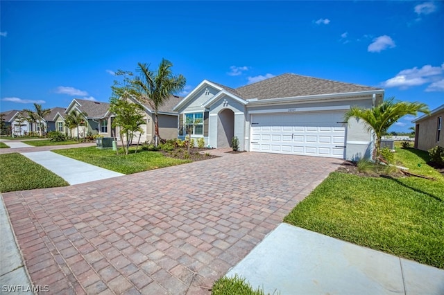 single story home with a garage, decorative driveway, a residential view, stucco siding, and a front lawn