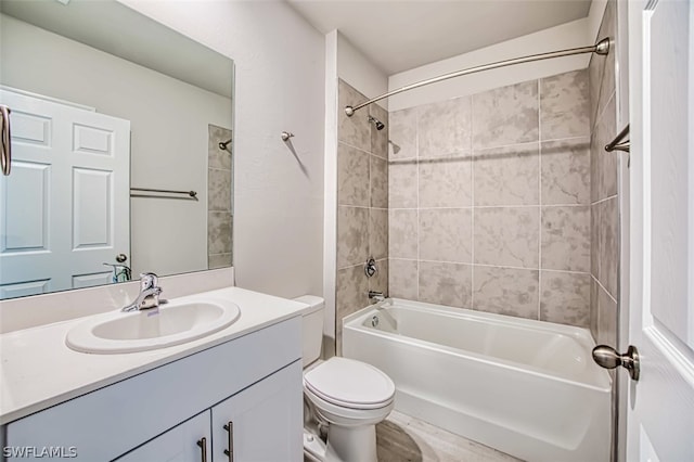 full bathroom with tiled shower / bath, vanity, and toilet