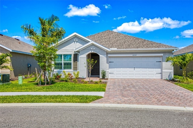 view of front of house featuring a garage and a front lawn