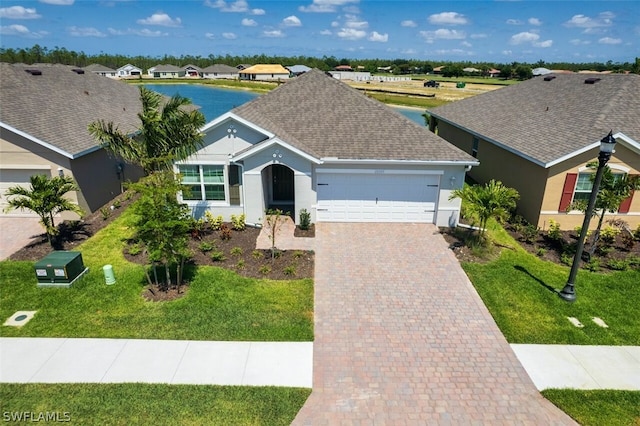 ranch-style home featuring a garage and a front lawn