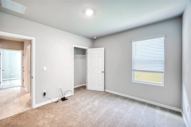 unfurnished bedroom featuring carpet floors and a closet