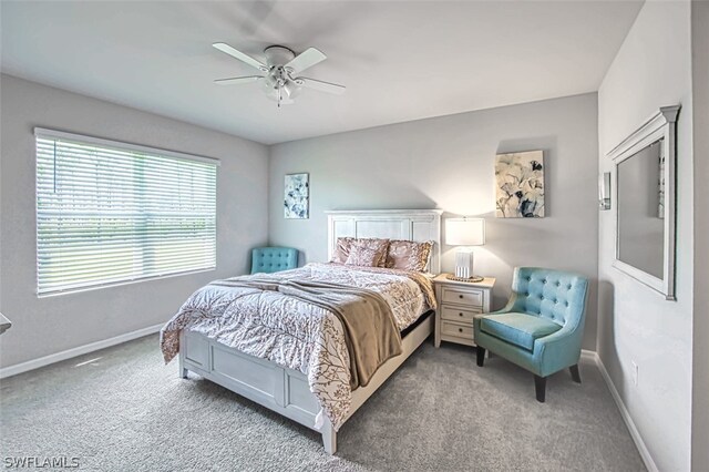 bedroom with ceiling fan and light colored carpet