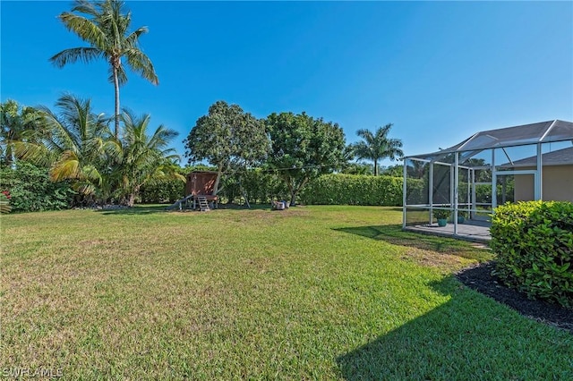 view of yard with glass enclosure