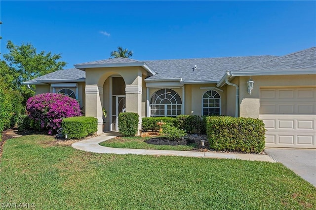 ranch-style house with a garage and a front lawn