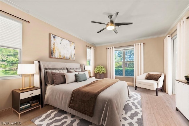 bedroom with light hardwood / wood-style floors, ceiling fan, and crown molding