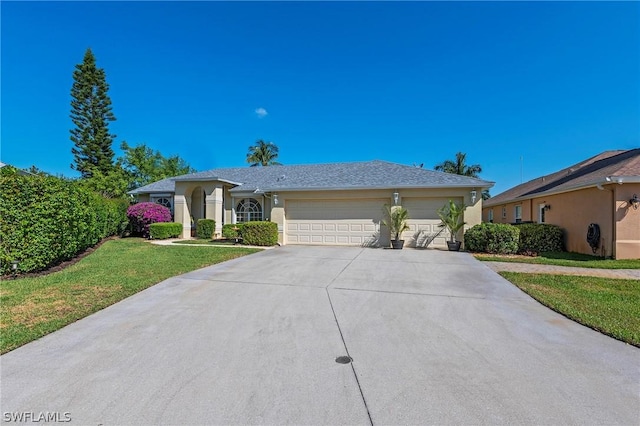 ranch-style house featuring a garage and a front lawn