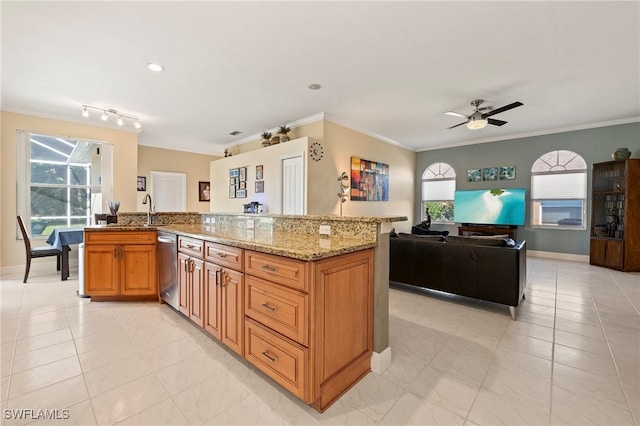 kitchen with ceiling fan, dishwasher, light stone counters, light tile patterned floors, and ornamental molding