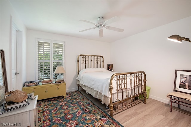 bedroom with hardwood / wood-style floors and ceiling fan