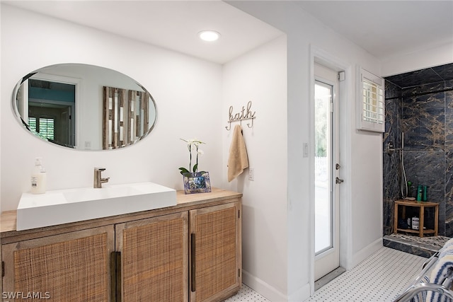 bathroom with tile flooring, tiled shower, and plenty of natural light