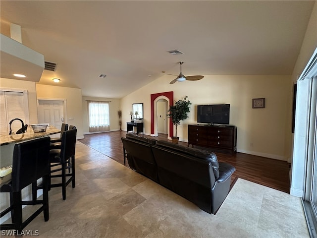 living room with tile flooring, vaulted ceiling, and ceiling fan