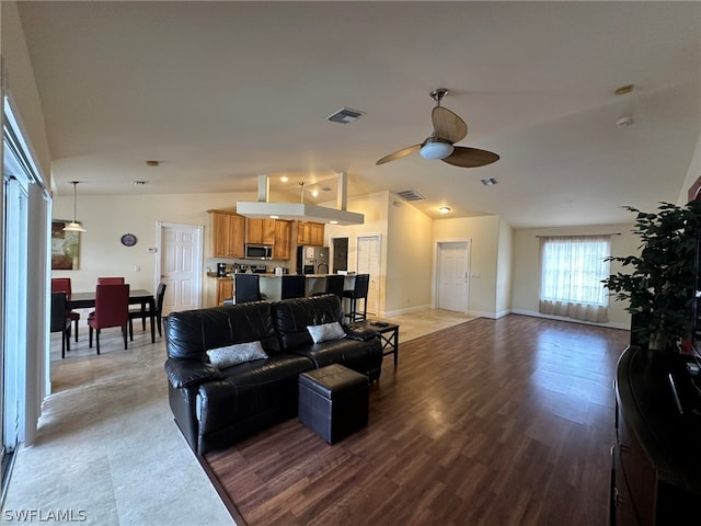 living room with vaulted ceiling, light hardwood / wood-style floors, and ceiling fan