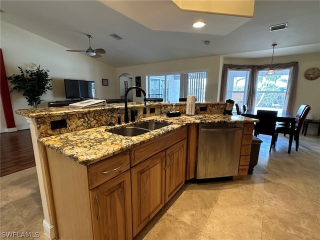 kitchen featuring light stone counters, vaulted ceiling, light tile floors, sink, and dishwasher