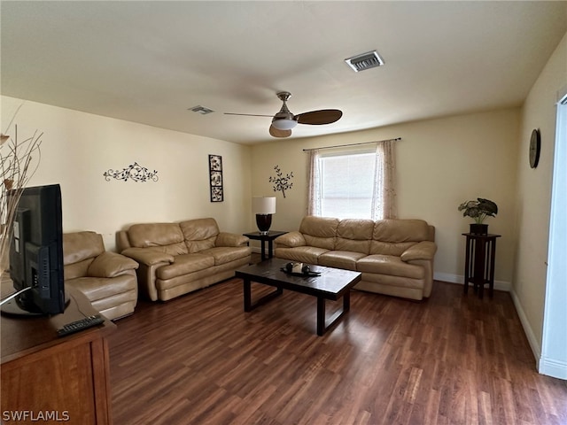 living room featuring dark hardwood / wood-style flooring and ceiling fan