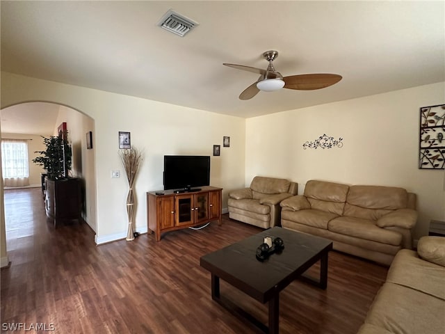 living room with dark hardwood / wood-style flooring and ceiling fan