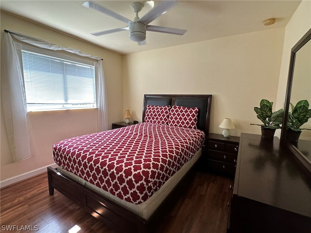 bedroom with dark hardwood / wood-style flooring and ceiling fan