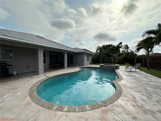 view of pool featuring a patio area, a grill, and an in ground hot tub