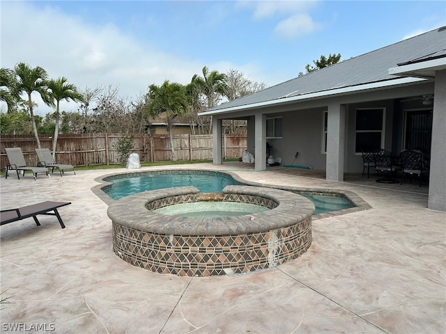 view of pool featuring a patio and an in ground hot tub