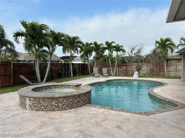 view of swimming pool with a patio area and an in ground hot tub